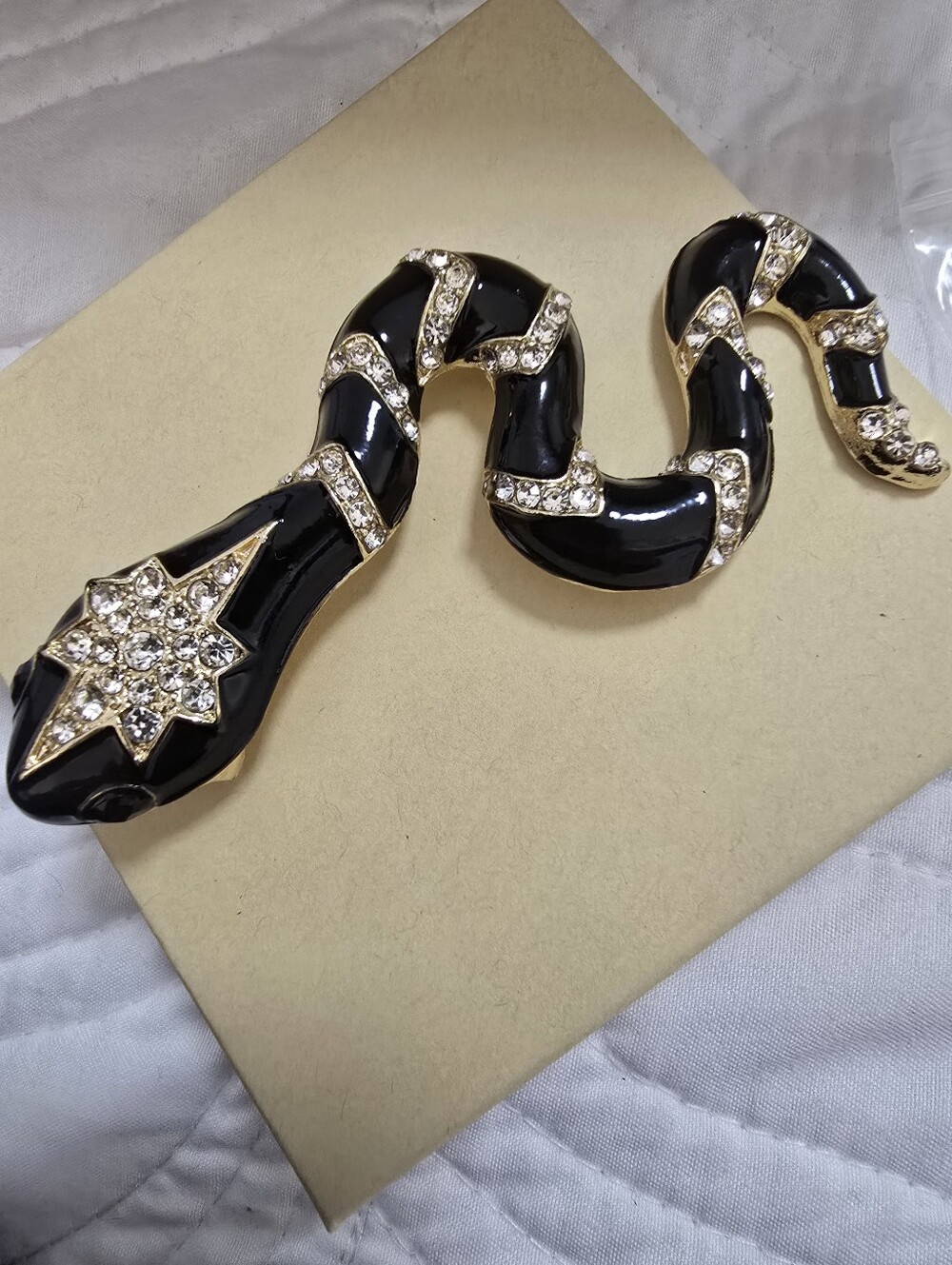 Elegant Black Enamel & Gold Snake Brooch with Crystal Accents
